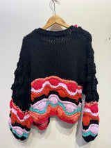 Gilet coloré avec pompons