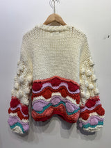 Gilet coloré avec pompons
