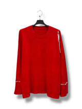 Pull col rond avec strass et perles aux poignets