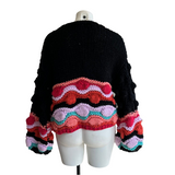 Gilet coloré avec pompons