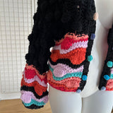 Gilet coloré avec pompons